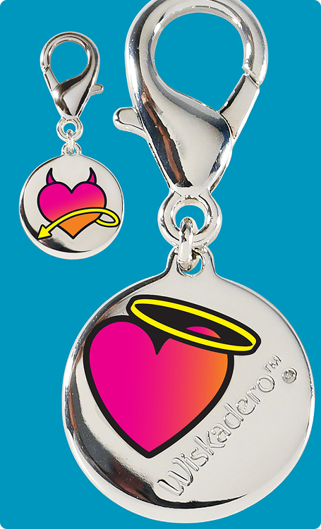 A silver-toned round charm with a large pink-to-orange heart, yellow halo, and black outline, shown with a smaller matching round charm and lobster clasp on a bright blue background. The larger charm is engraved with the brand name Wiskedato.