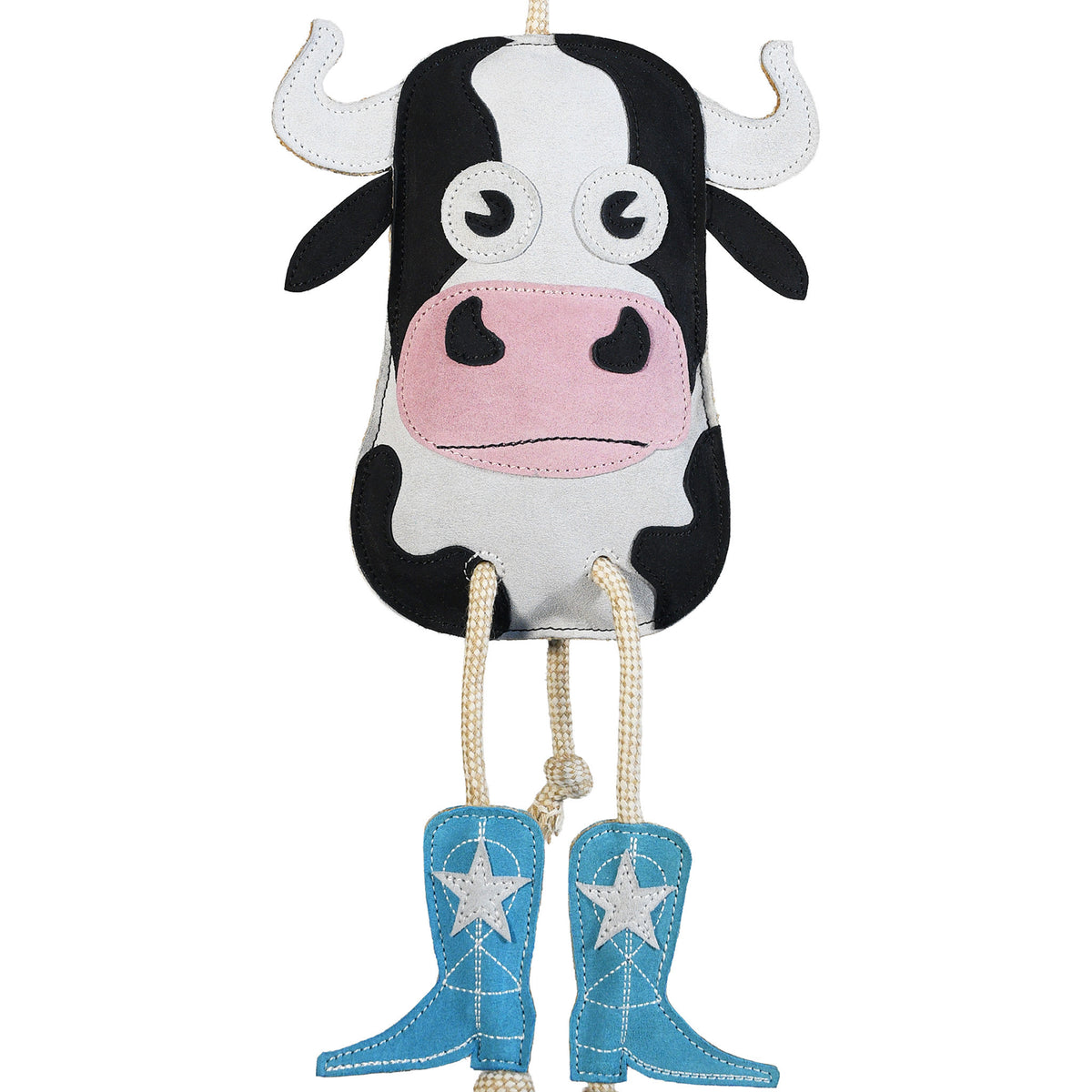 Close-up front view of the Wiskadero Cow Pie toy showing the black and white suede cow head, white suede horns, pink suede snout, pull-through natural rope tail, and turquoise suede cowboy boots with white embroidered stars.