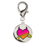 Front view of the Wiskadero Halo and Horns bridle charm featuring a round silver-toned medallion with an enameled gradient pink heart, black devil horns, and a yellow swooping arrow, attached to a top lobster clasp.