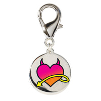 Front view of the Wiskadero Halo and Horns bridle charm featuring a round silver-toned medallion with an enameled gradient pink heart, black devil horns, and a yellow swooping arrow, attached to a top lobster clasp.