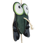 Enlarged 3/4 angle side view of the Wiskadero Shoofly equine boredom buster toy. Highlights the dark green suede body, oversized cartoon eyes, dark gray wings with black leg overlays, and the knotted natural rope pull-through nose.