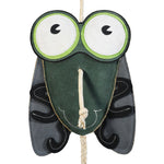 Close-up front view of the Wiskadero Shoofly equine boredom buster toy. Highlights the fly-shaped dark green suede body, oversized green and white cartoon eyes, and a natural rope pull-through nose.