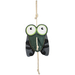 Wiskadero Shoofly equine boredom buster toy in full front view. Features a fly-shaped dark green and black suede body with oversized cartoon eyes in white and green, plus a natural rope hanging loop at the top and rope tail at the bottom.