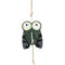 Wiskadero Shoofly equine boredom buster toy in full front view. Features a fly-shaped dark green and black suede body with oversized cartoon eyes in white and green, plus a natural rope hanging loop at the top and rope tail at the bottom.