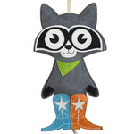 Close-up front view of the Wiskadero Trash Panda toy showing the gray suede body, black eye mask with white suede eyes, lime green bandana, pull-through natural rope tail, and mismatched turquoise and orange cowboy boots with white embroidered stars.